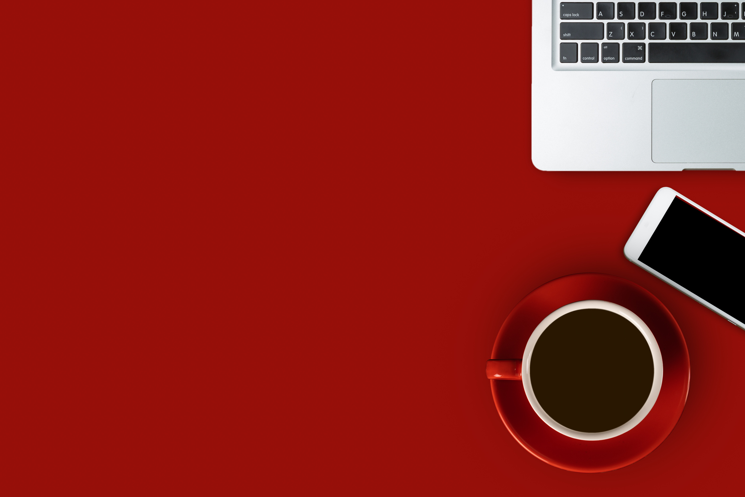 Red desk flat lay with black coffee in red cup